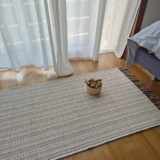 small cream rug with colorful lines