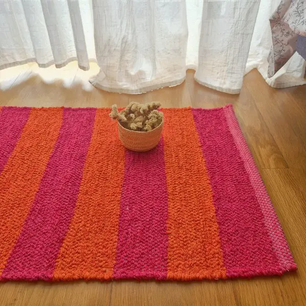 pink and orange striped rug