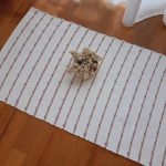 small white and old rose knotted rug