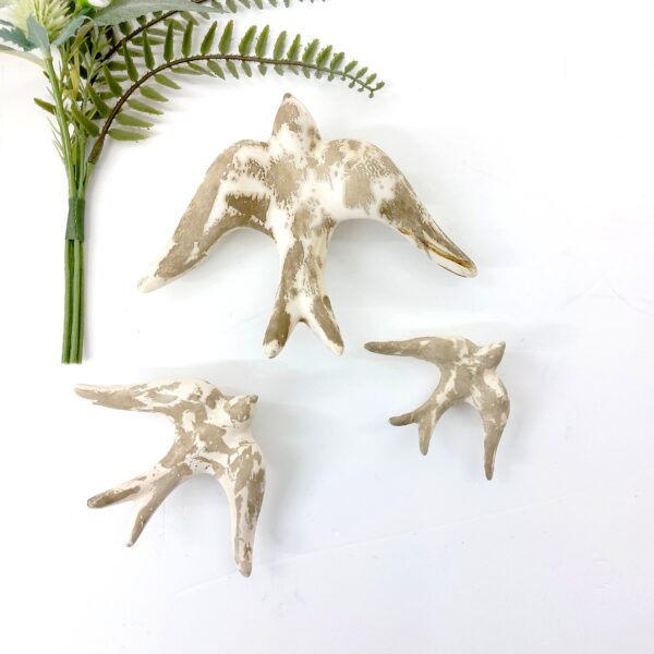 Glazed cream stone swallows
