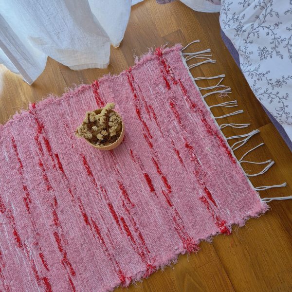 small pink and red rug made from recycled materials